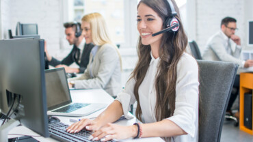 A beautiful woman assisting clients through a call center